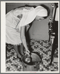 FSA (Farm Security Administration) supervisor giving a demonstration of pressure canning before a group of FSA officials at a district meeting. San Angelo, Texas. She is removing cans from pressure cooker