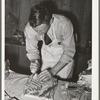 FSA (Farm Security Administration) supervisor giving a demonstration of meat cutting before a group of FSA officials and supervisor at a district meeting in San Angelo, Texas