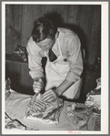 FSA (Farm Security Administration) supervisor giving a demonstration of meat cutting before a group of FSA officials and supervisor at a district meeting in San Angelo, Texas