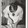 FSA (Farm Security Administration) supervisor giving a demonstration of meat cutting before a group of FSA officials and supervisor at a district meeting in San Angelo, Texas
