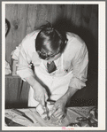 FSA (Farm Security Administration) supervisor giving a demonstration of meat cutting before a group of FSA officials and supervisor at a district meeting in San Angelo, Texas