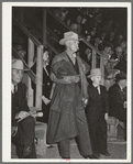 Cattleman with his grandson at auction of beef steers and breeding stock at the San Angelo Fat Stock Show. San Angelo, Texas. The Stetson hat, leather coat and boots are standard everyday wear of ranchmen