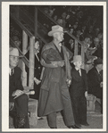 Cattleman with his grandson at auction of beef steers and breeding stock at the San Angelo Fat Stock Show. San Angelo, Texas. The Stetson hat, leather coat and boots are standard everyday wear of ranchmen