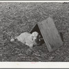 Kid in front of individual shelter on ranch in Kimble County, Texas