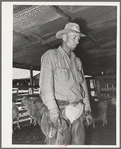 Neighboring ranchman who has been hired to help out during the kidding and shearing on ranch of rehabilitation borrower in Kimble County, Texas