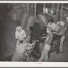 Weighing a sack of mohair at the Kimble County Wool and Mohair Company warehouse, Junction, Texas. These sacks weigh close to three hundred pounds