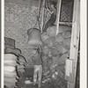 Hoisting a sack of mohair in place in the warehouse of the Kimble County Wool and Mohair Company. Junction, Texas