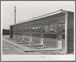 Front of row shelter for migratory workers at the migratory labor camp. Sinton, Texas