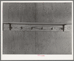 Shelf and hooks in one of the row shelters for migratory workers at the migratory labor camp at Sinton, Texas