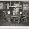 Dining table in Navajo Lodge, Datil, New Mexico. The center of the table which is raised is mounted on an old wagon wheel hub and revolves with the food before those seated around the table