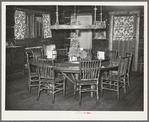 Dining table in Navajo Lodge, Datil, New Mexico. The center of the table which is raised is mounted on an old wagon wheel hub and revolves with the food before those seated around the table