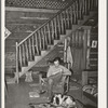 Manager of the Navajo Lodge with his dog before the fireplace on a snowy afternoon. Datil, New Mexico