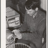 Member of the Arizona part-time farms (Chandler Unit, Maricopa County, Arizona) candling eggs