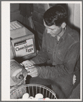 Member of the Arizona part-time farms (Chandler Unit, Maricopa County, Arizona) candling eggs