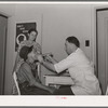 Examination by doctor at the clinic of the Agua Fria migratory labor camp. Arizona