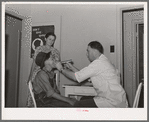 Examination by doctor at the clinic of the Agua Fria migratory labor camp. Arizona