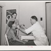 Examination by doctor at the clinic of the Agua Fria migratory labor camp. Arizona