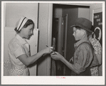 Nurse giving instructions to son of migratory laborer as to how to take medicine. Agua Fria migratory labor camp, Arizona