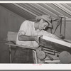 Migratory agricultural laborer making toys for the WPA (Work Projects Administration) nursery school at the Agua Fria migratory labor camp. Arizona