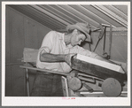 Migratory agricultural laborer making toys for the WPA (Work Projects Administration) nursery school at the Agua Fria migratory labor camp. Arizona