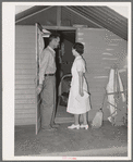 Nurse making a call at one of the individual metal shelters at the Agua Fria migratory labor camp. Arizona