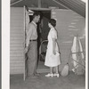 Nurse making a call at one of the individual metal shelters at the Agua Fria migratory labor camp. Arizona