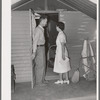 Nurse making a call at one of the individual metal shelters at the Agua Fria migratory labor camp. Arizona