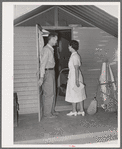 Nurse making a call at one of the individual metal shelters at the Agua Fria migratory labor camp. Arizona