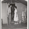 Nurse making a call at one of the individual metal shelters at the Agua Fria migratory labor camp. Arizona