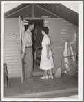 Nurse making a call at one of the individual metal shelters at the Agua Fria migratory labor camp. Arizona