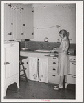 Wife of member of the Arizona part-time farms. Chandler Unit, Maricopa County, Arizona, in the kitchen of her apartment on the project