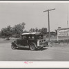 Migratory agricultural worker and his family leaving the Agua Fria migratory labor camp, Arizona. He was headed for California