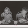 Children eating lunch at WPA (Work Projects Administration) nursery school at the Agua Fria migratory labor camp. Arizona