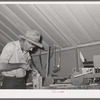 Migratory agricultural laborer making toys for the WPA (Work Projects Administration) nursery school at the Agua Fria migratory labor camp, Arizona