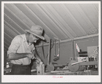 Migratory agricultural laborer making toys for the WPA (Work Projects Administration) nursery school at the Agua Fria migratory labor camp, Arizona