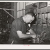 Member of the service department of the United Producers and Consumers Cooperative winding an armature. He was sent by the cooperative to Chicago to learn his trade