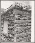 Detail of corner of slab house, Pie Town, New Mexico. Sawmill gives these slabs to farmers who will haul them away;