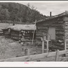 Side of house of Jack Whinery, farmer at Pie Town, New Mexico. Whinery came to Pie Town last fall from Texas where he had been a farm day laborer. The dugout was built first, small room in foreground added later