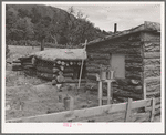 Side of house of Jack Whinery, farmer at Pie Town, New Mexico. Whinery came to Pie Town last fall from Texas where he had been a farm day laborer. The dugout was built first, small room in foreground added later