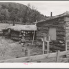 Side of house of Jack Whinery, farmer at Pie Town, New Mexico. Whinery came to Pie Town last fall from Texas where he had been a farm day laborer. The dugout was built first, small room in foreground added later