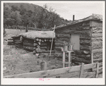 Side of house of Jack Whinery, farmer at Pie Town, New Mexico. Whinery came to Pie Town last fall from Texas where he had been a farm day laborer. The dugout was built first, small room in foreground added later