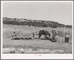 Faro Caudill drawing water. He will haul to his house. About a week after this picture was taken, Caudill tore down his original dugout and rebuilt it near this well. Pie Town, New Mexico