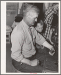 Mr. Besson, formerly an Oklahoma tenant farmer, playing Forty-two at party after literary society. Pie Town, New Mexico