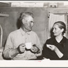 Mr. and Mrs. Besson eating cake and coffee at a Forty-two party at their home. Pie Town, New Mexico. They farmed in Oklahoma near Frederick before homesteading to Pie Town