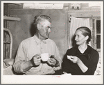 Mr. and Mrs. Besson eating cake and coffee at a Forty-two party at their home. Pie Town, New Mexico. They farmed in Oklahoma near Frederick before homesteading to Pie Town