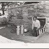 Faro Caudill, homesteader, coming up out of his dugout. Pie Town, New Mexico