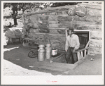 Faro Caudill, homesteader, coming up out of his dugout. Pie Town, New Mexico