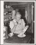 Mrs. Holley Sr. eating ice cream from the dasher. Pie Town, New Mexico