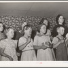 Children at the private school held in the Farm Bureau building keeping time with homemade musical instruments with a phonograph. Pie Town, New Mexico