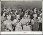 Children at the private school held in the Farm Bureau building keeping time with homemade musical instruments with a phonograph. Pie Town, New Mexico